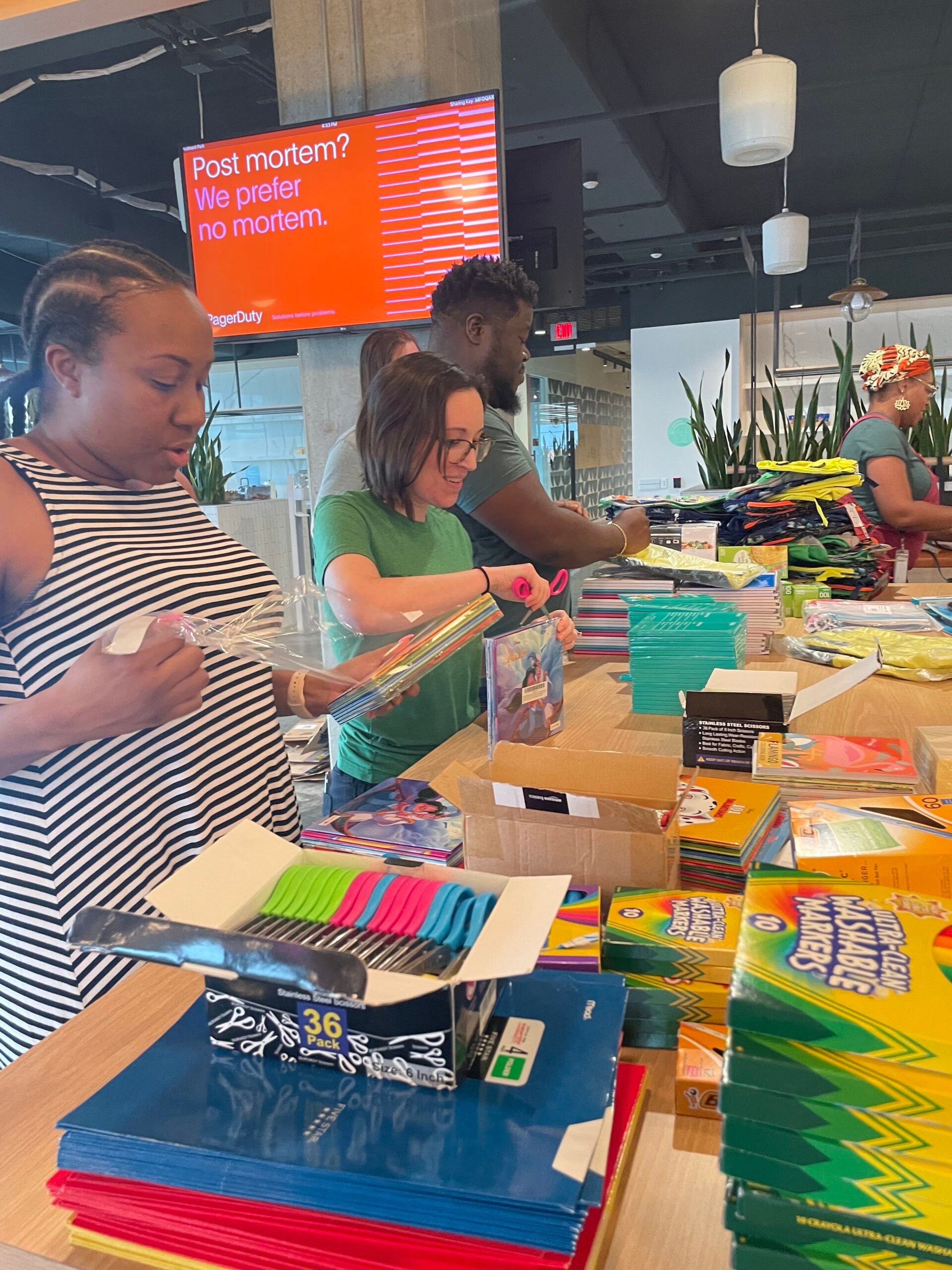Array:Black ERG and fellow Atlanta Dutonians assemble backpacks as part of a Back-To-School fundraiser