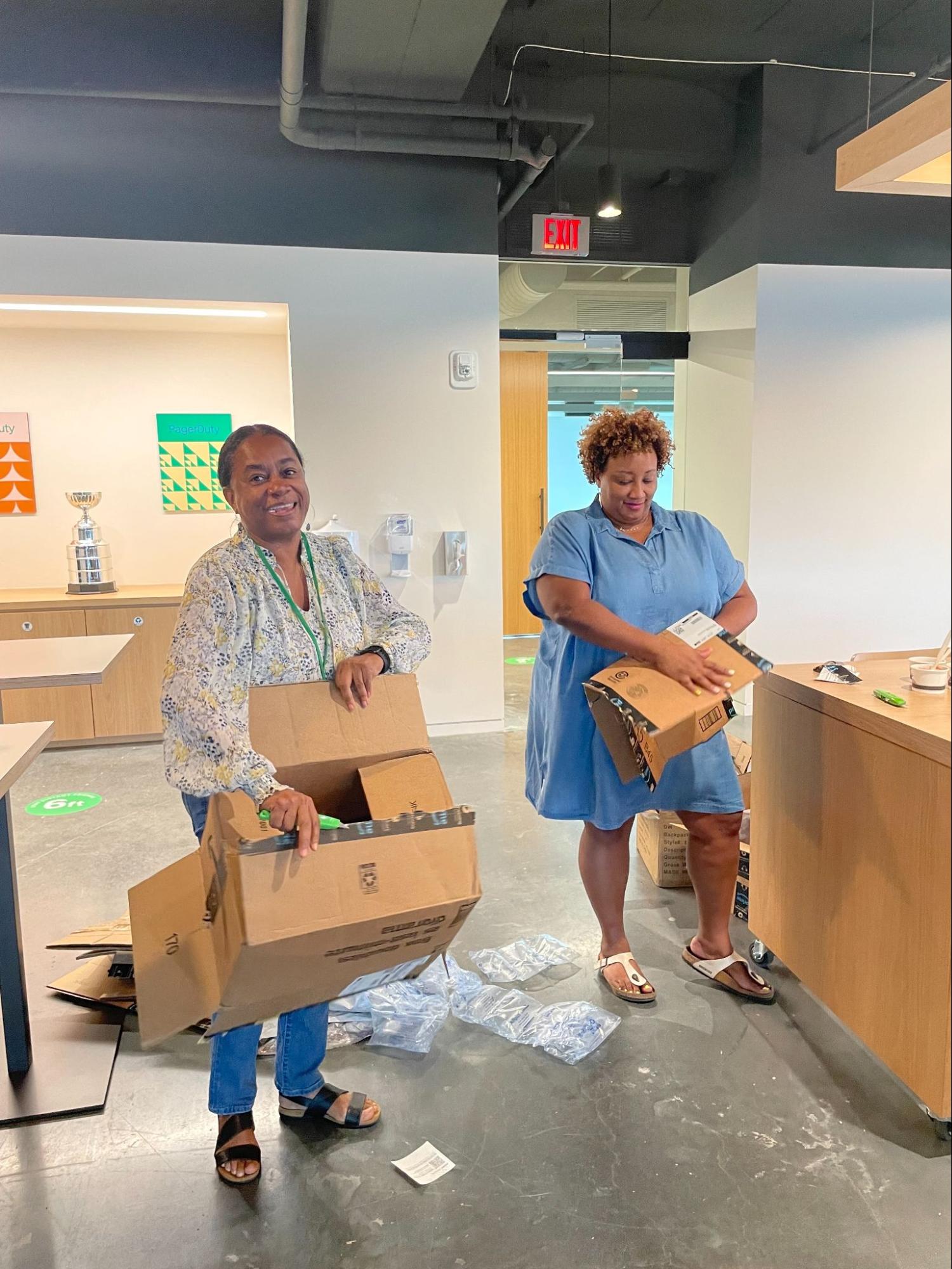Dutonians breaking down boxes as part of backpack donation