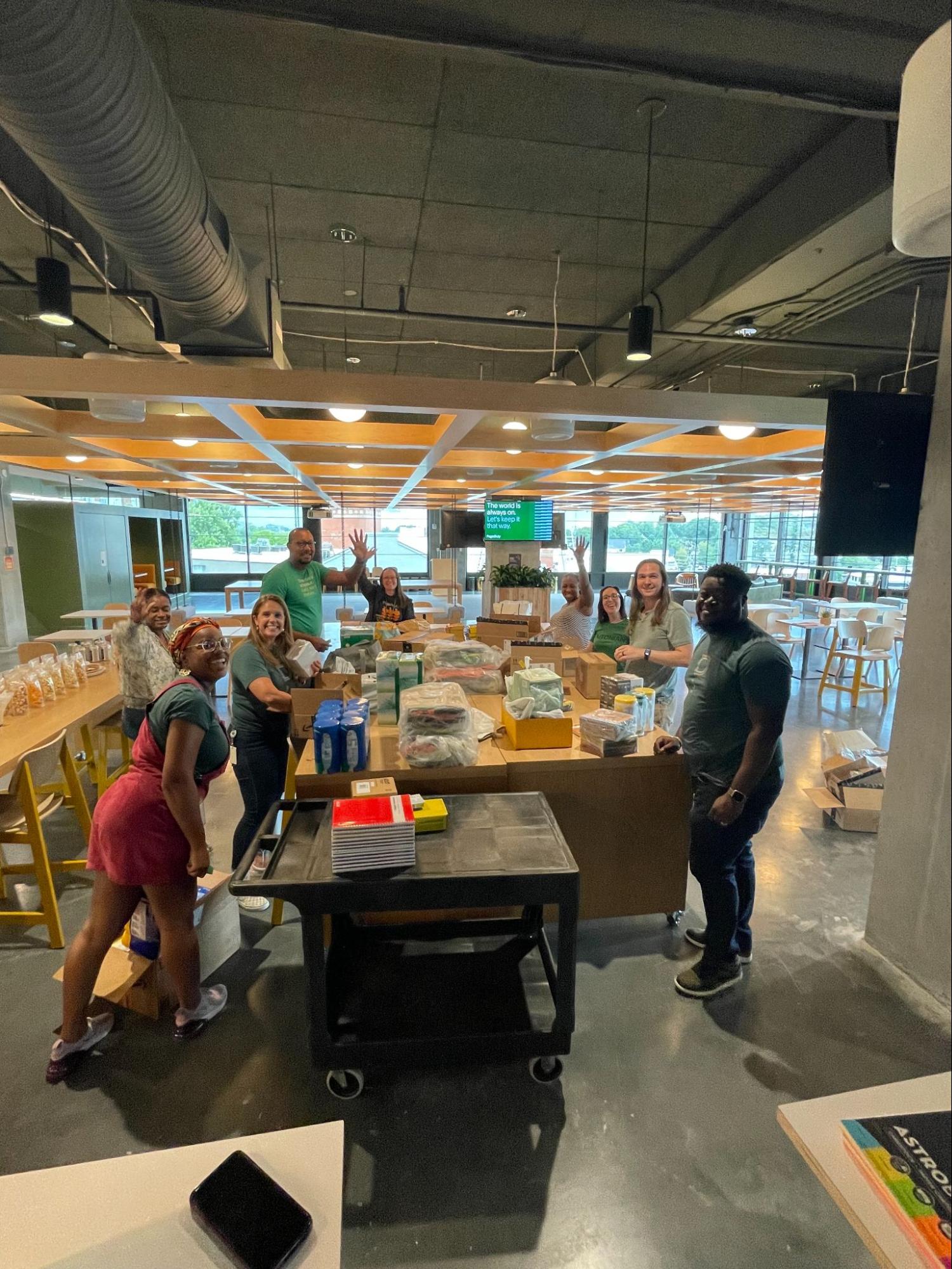 Dutonians gathered at desk putting together backpack donations