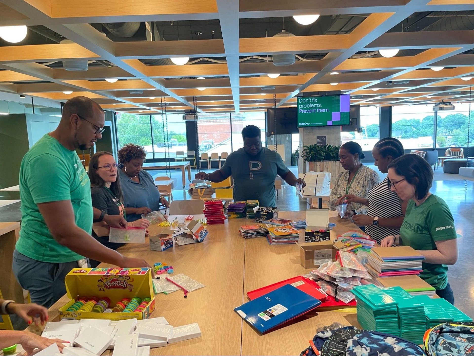 Dutonians gathered at desk putting together backpack donations