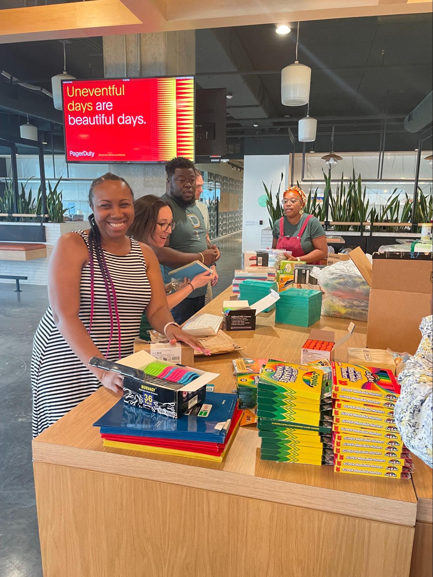 Dutonians gathered at desk putting together backpack donations
