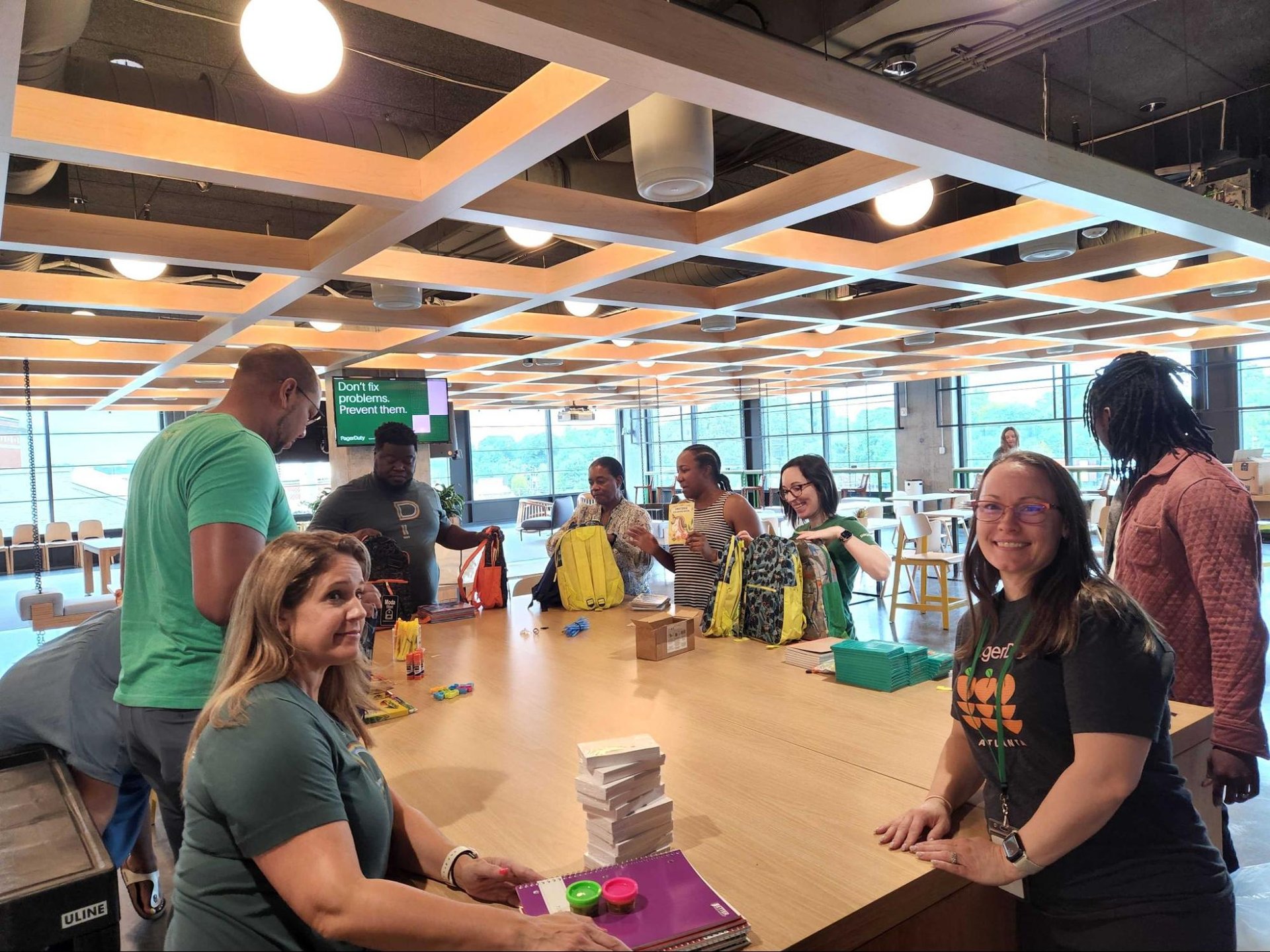 Dutonians gathered at desk putting together backpack donations
