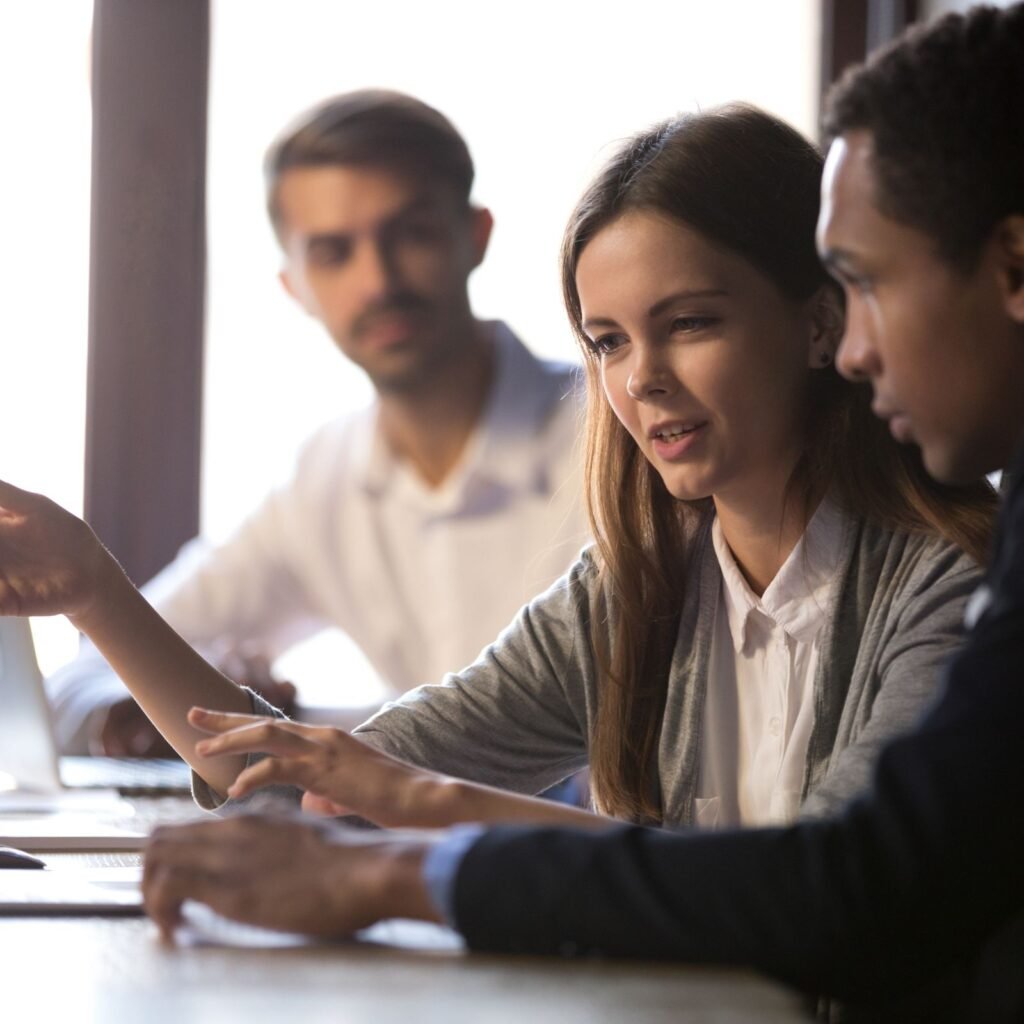 Picture of people collaborating at desk.