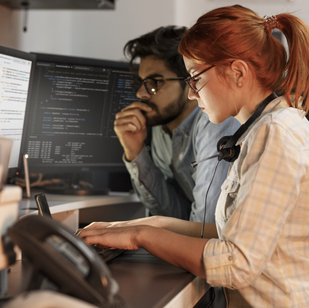 Two people sitting at a computer.